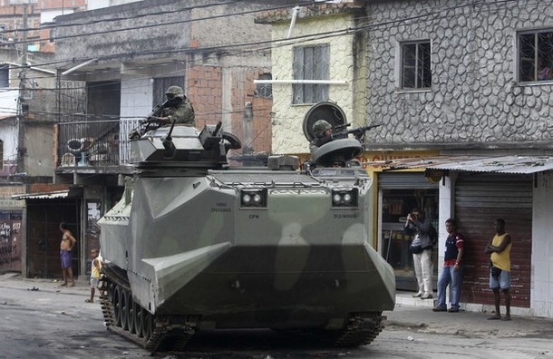 Brazilian army soldiers patrol with an armoured vehicle during an operation at Vila Cruzeiro slum in Rio de Janeiro